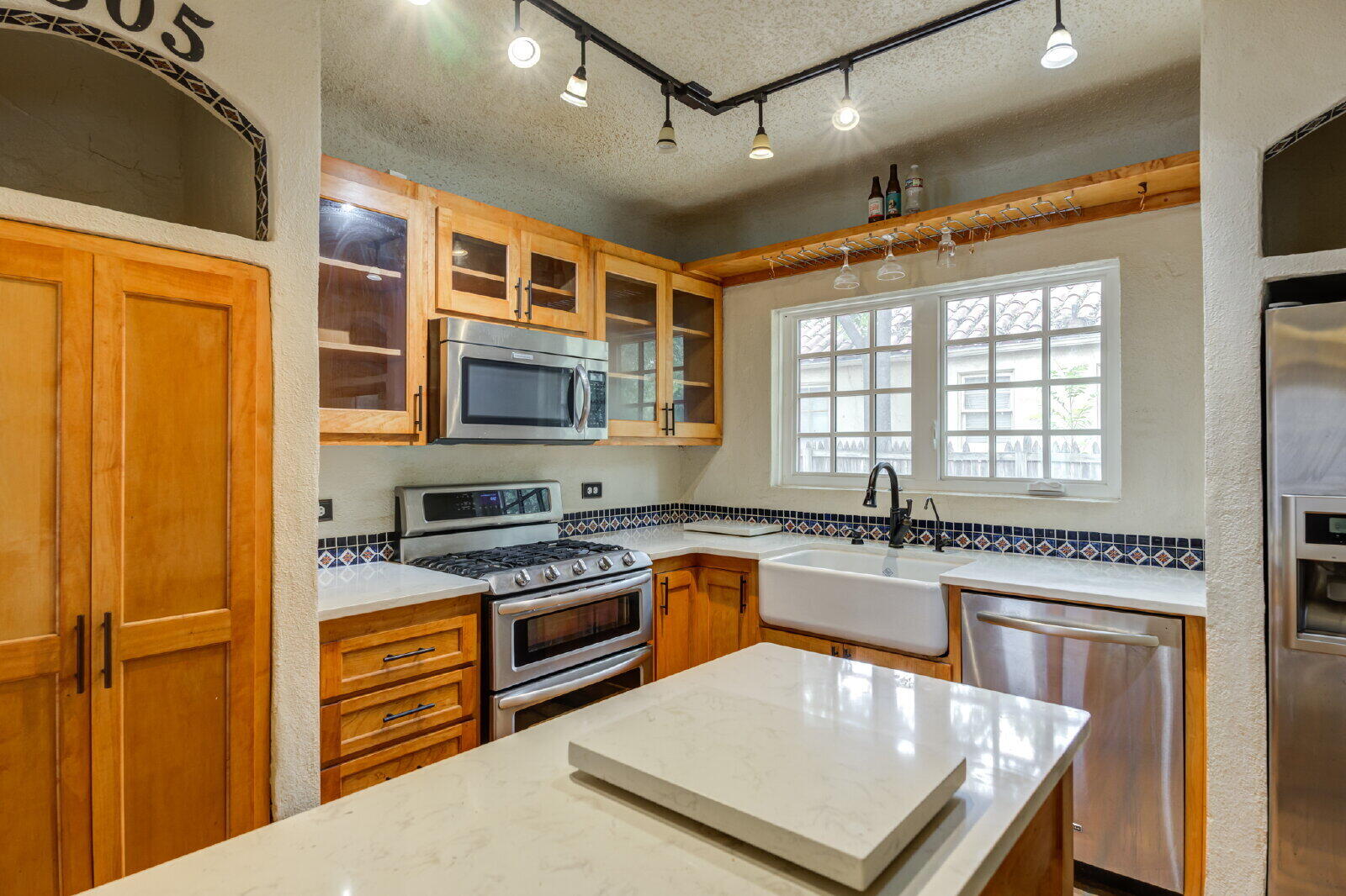 2305 18th Street, Unit FRONT Lubbock, TX 79401 - Photo 28 of 73 a kitchen with stainless steel appliances granite countertop a stove a sink dishwasher and a refrigerator