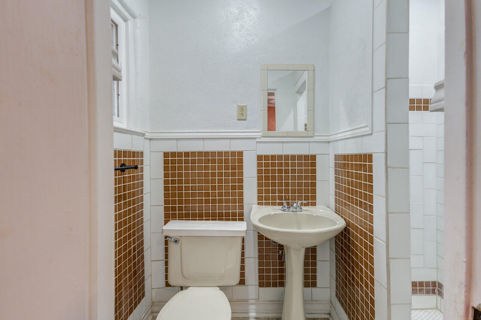 2305 18th Street, Unit FRONT Lubbock, TX 79401 - Photo 41 of 73 a bathroom with a sink toilet and mirror