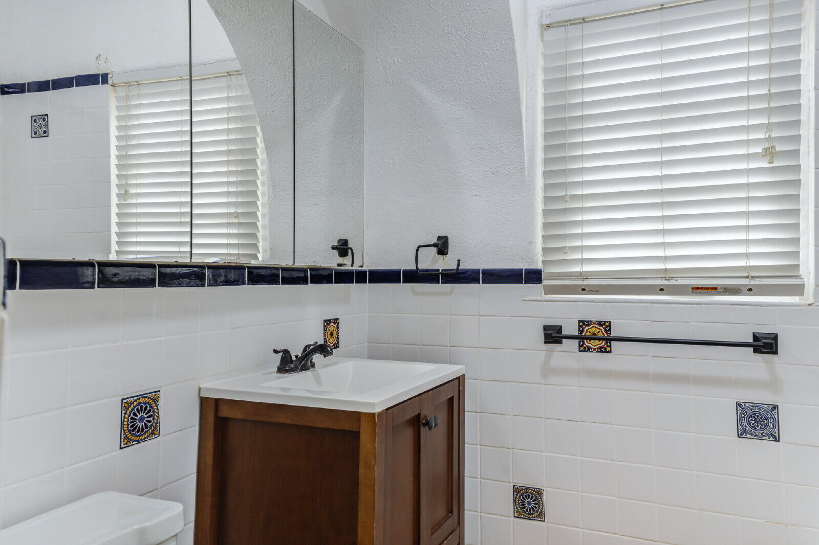 2305 18th Street, Unit FRONT Lubbock, TX 79401 - Photo 46 of 73 a bathroom with a sink and a mirror