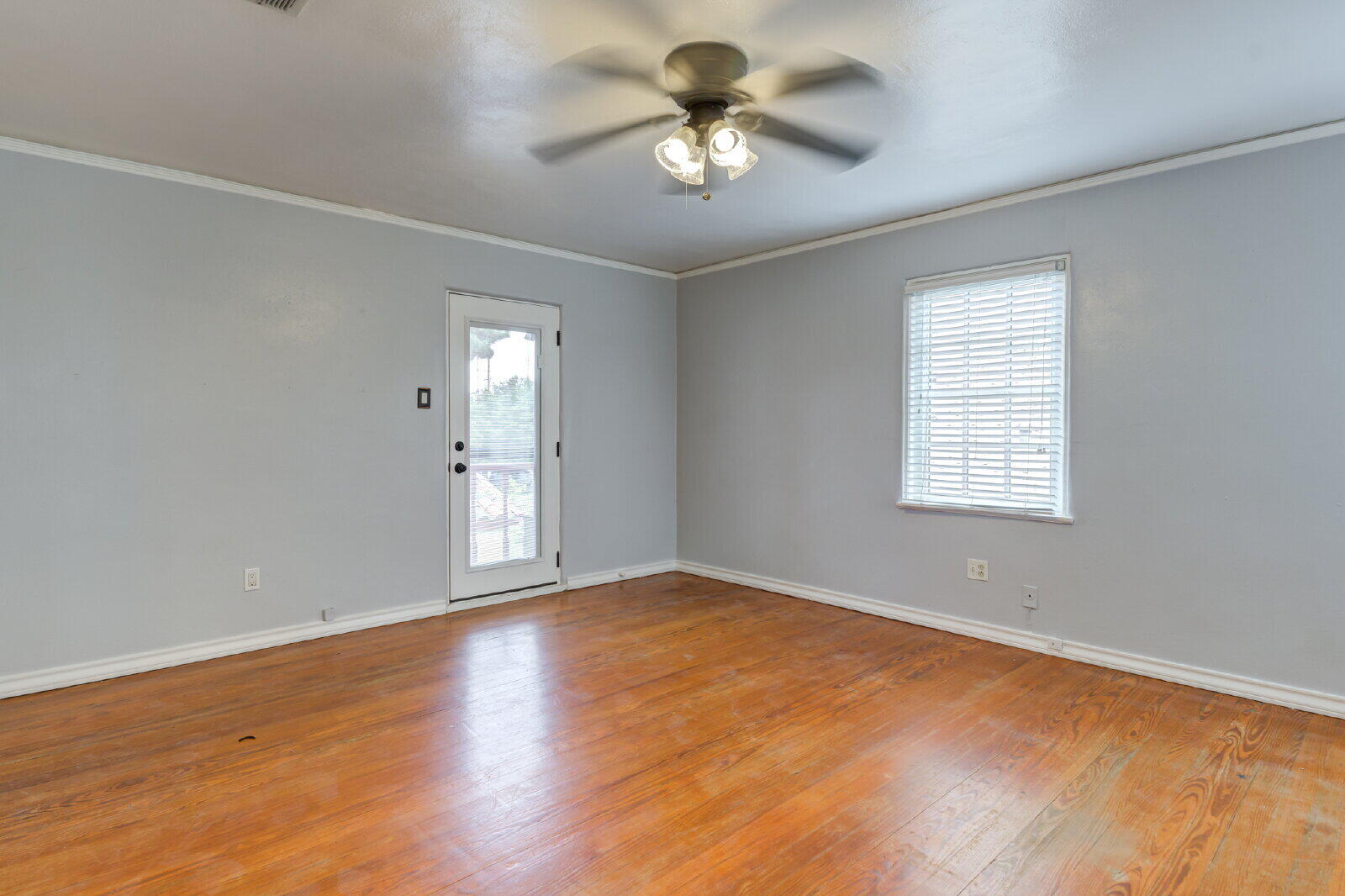 2305 18th Street, Unit FRONT Lubbock, TX 79401 - Photo 55 of 73 wooden floor in an empty room with a window