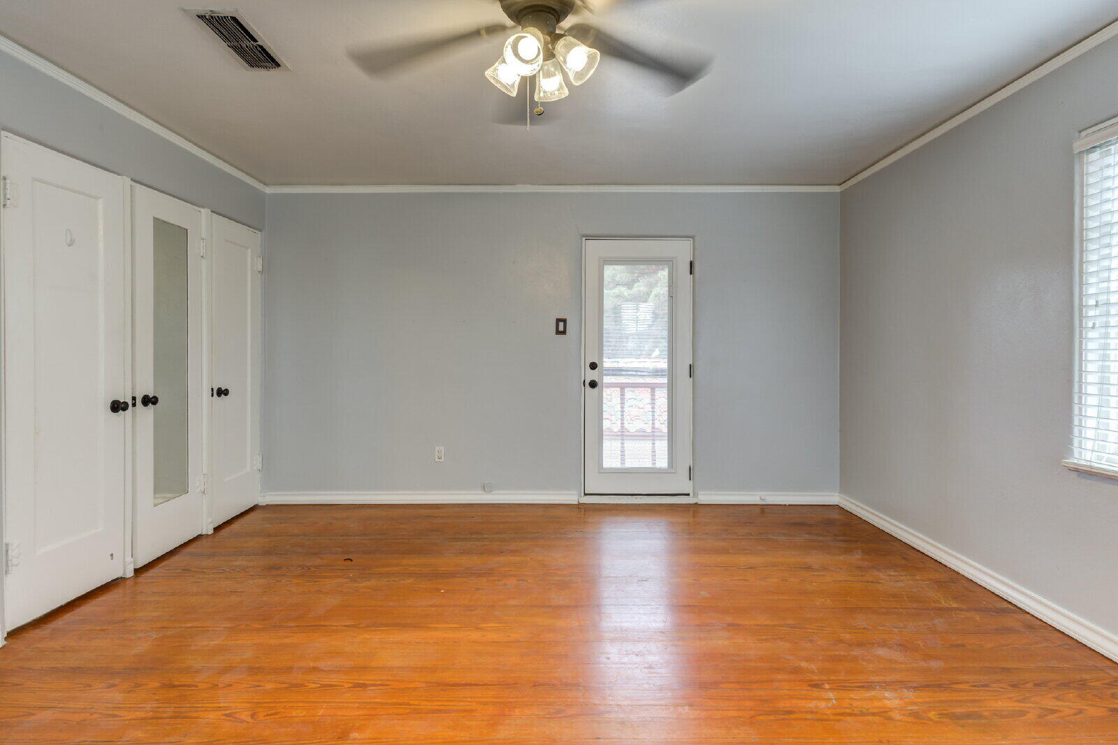 2305 18th Street, Unit FRONT Lubbock, TX 79401 - Photo 56 of 73 a view of an empty room with wooden floor and a window