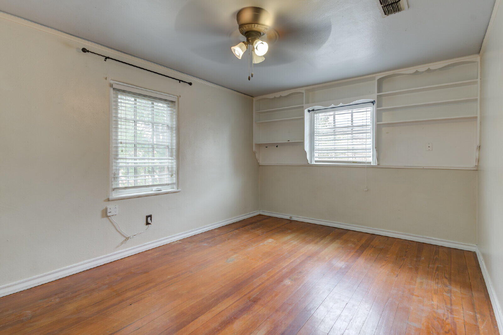 2305 18th Street, Unit FRONT Lubbock, TX 79401 - Photo 59 of 73 a view of an empty room with wooden floor and a window