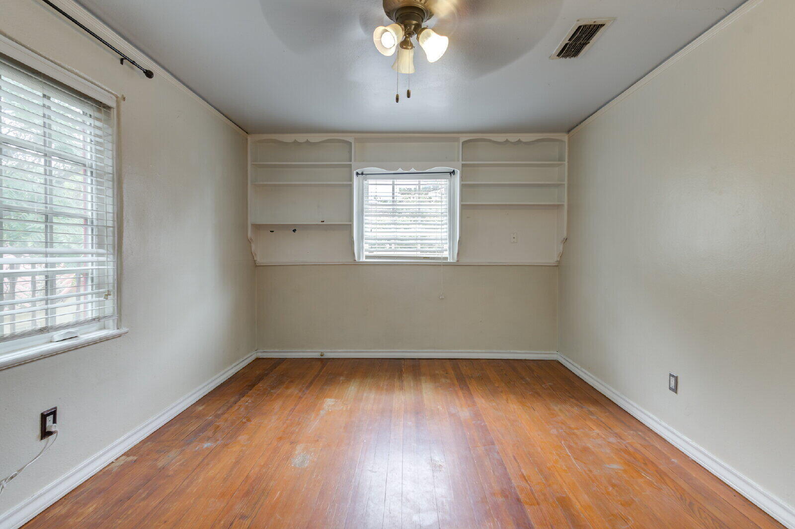 2305 18th Street, Unit FRONT Lubbock, TX 79401 - Photo 61 of 73 wooden floor in an empty room with a window