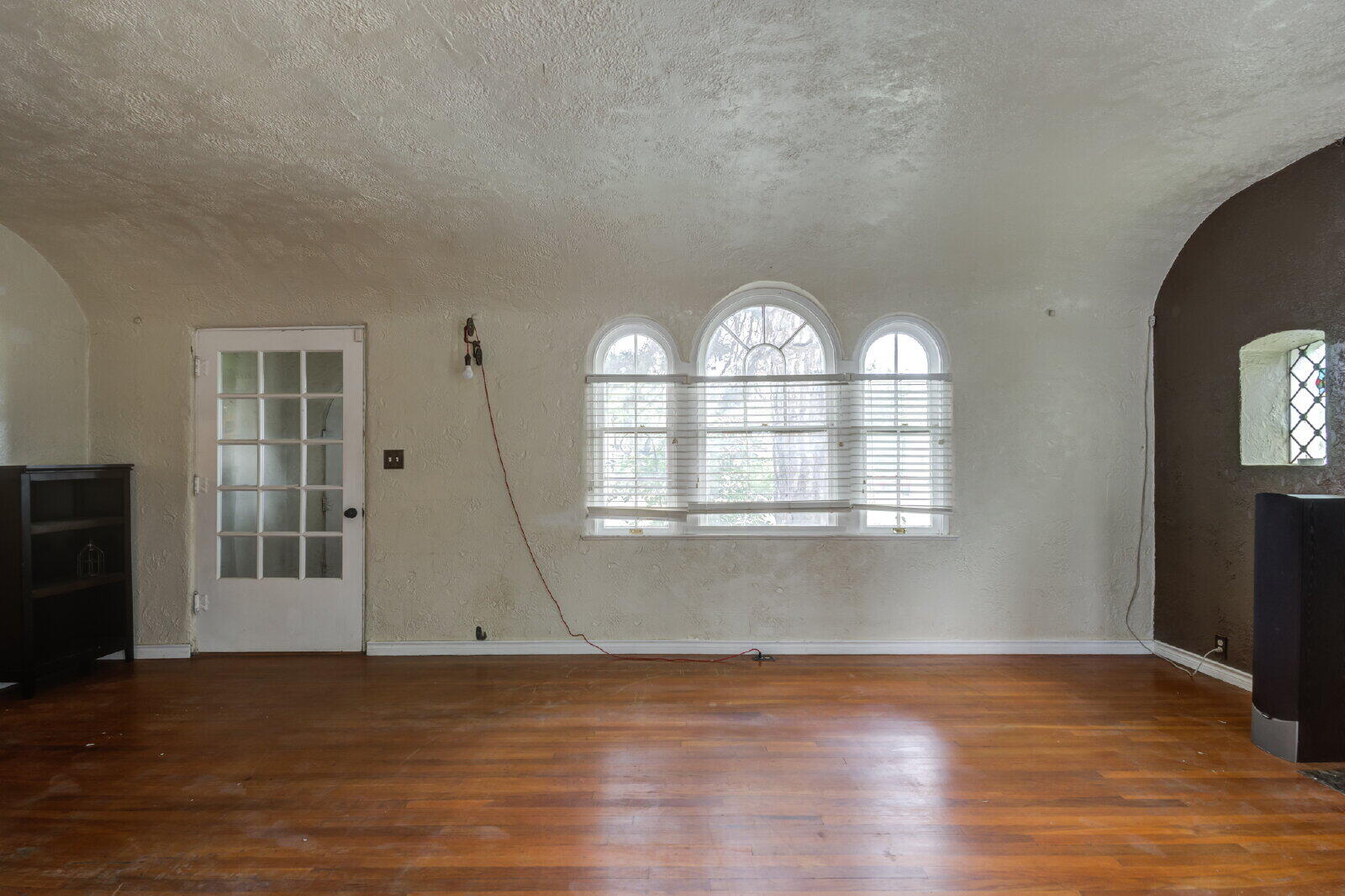 2305 18th Street, Unit FRONT Lubbock, TX 79401 - Photo 9 of 73 an empty room with wooden floor cabinet and windows