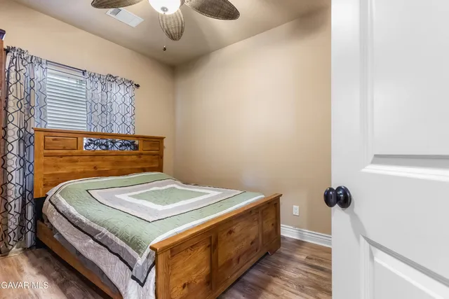 a view of a hallway with wooden floor and closet