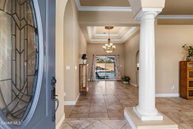 a view of a hallway with wooden floor and a living room