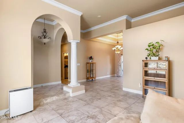 a view of a hallway with entryway and stairs
