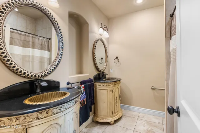 a bathroom with a sink mirror vanity and a mirror