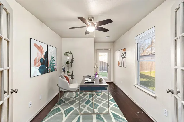 a bedroom with a bed a window and flat screen television