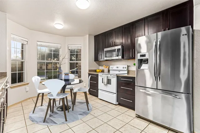 an empty room with a ceiling fan and a window