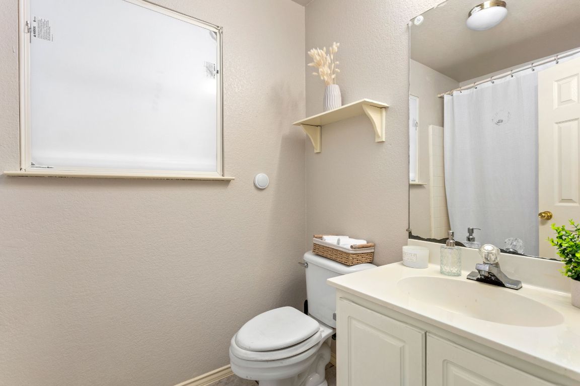 409 Lydia Lane Thrall, TX 76578 - Photo 24 of 39 a bathroom with a sink a toilet and mirror