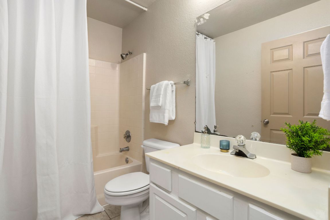 409 Lydia Lane Thrall, TX 76578 - Photo 28 of 39 a bathroom with a sink a toilet and a mirror