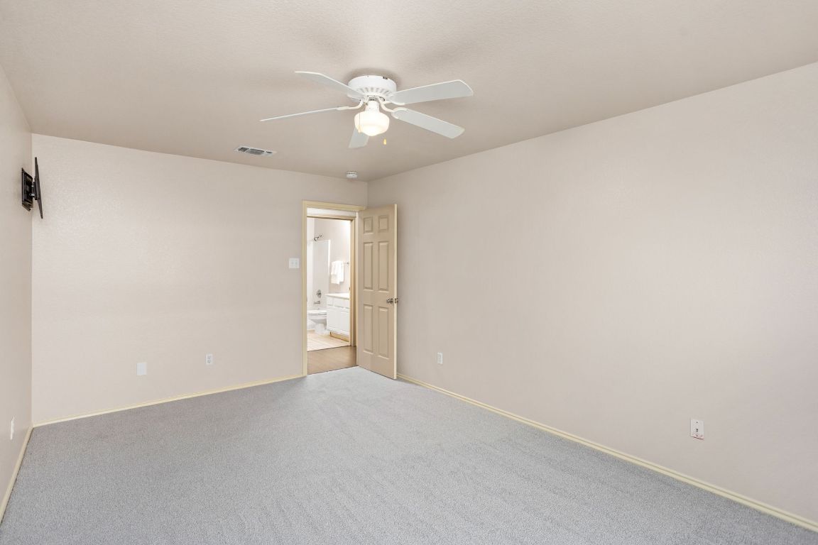 409 Lydia Lane Thrall, TX 76578 - Photo 31 of 39 a view of an empty room with a chandelier fan
