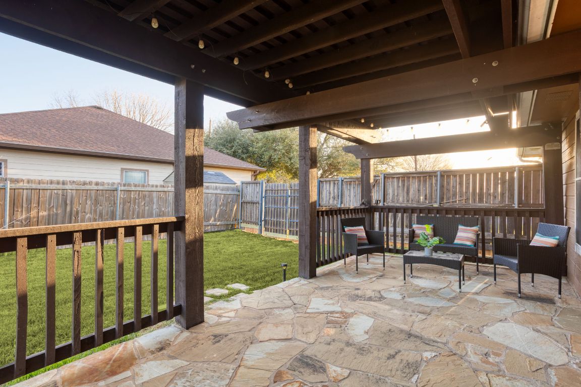 409 Lydia Lane Thrall, TX 76578 - Photo 32 of 39 a view of a patio with a table chairs and a backyard