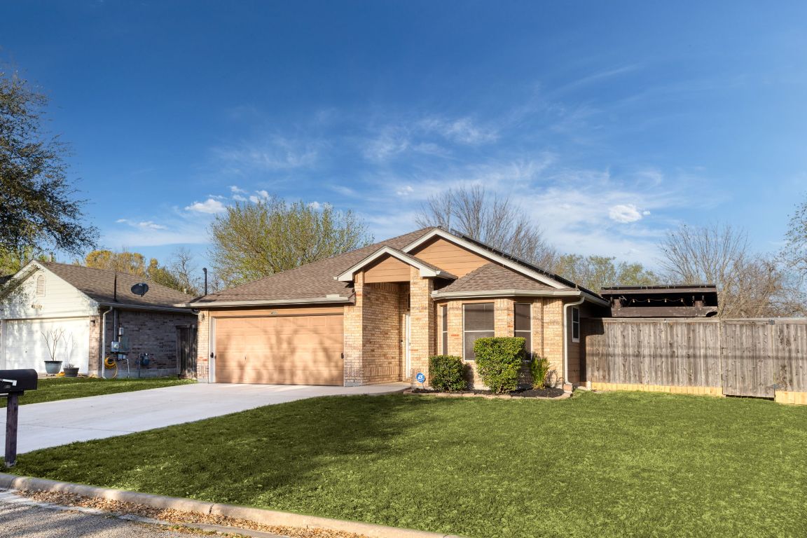 409 Lydia Lane Thrall, TX 76578 - Photo 4 of 39 a front view of a house with a garden