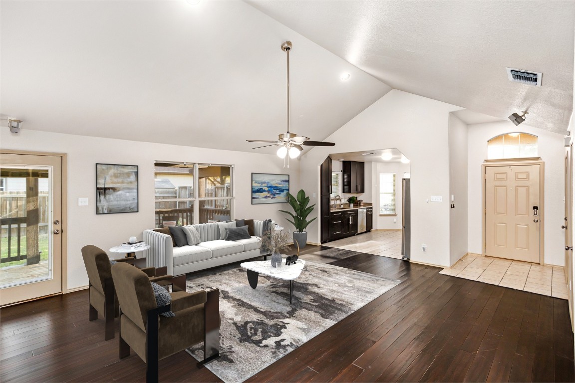 409 Lydia Lane Thrall, TX 76578 - Photo 5 of 39 a living room with furniture a chandelier and wooden floor