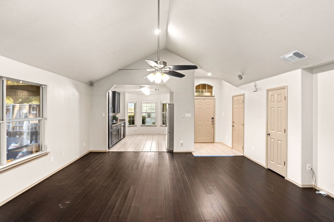 409 Lydia Lane Thrall, TX 76578 - Photo 10 of 39 a view of a big room with wooden floor chandelier and windows