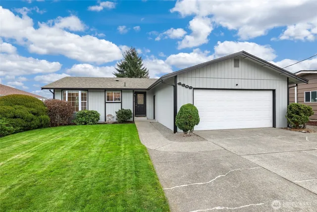 a front view of house with yard and green space