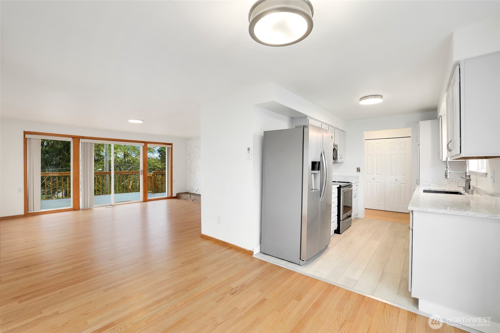 4609 North Vassault Street Tacoma, WA 98407 - Photo 12 of 37 a view of a kitchen with a stove fridge and wooden floor