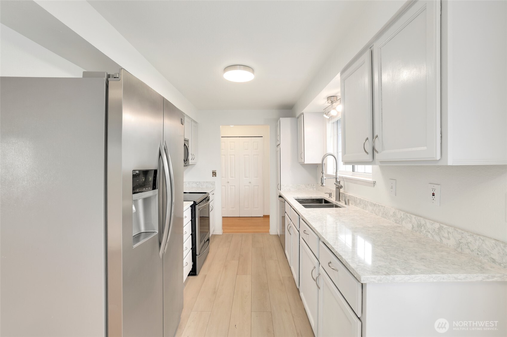 4609 North Vassault Street Tacoma, WA 98407 - Photo 13 of 37 a kitchen with stainless steel appliances granite countertop a sink stove and refrigerator