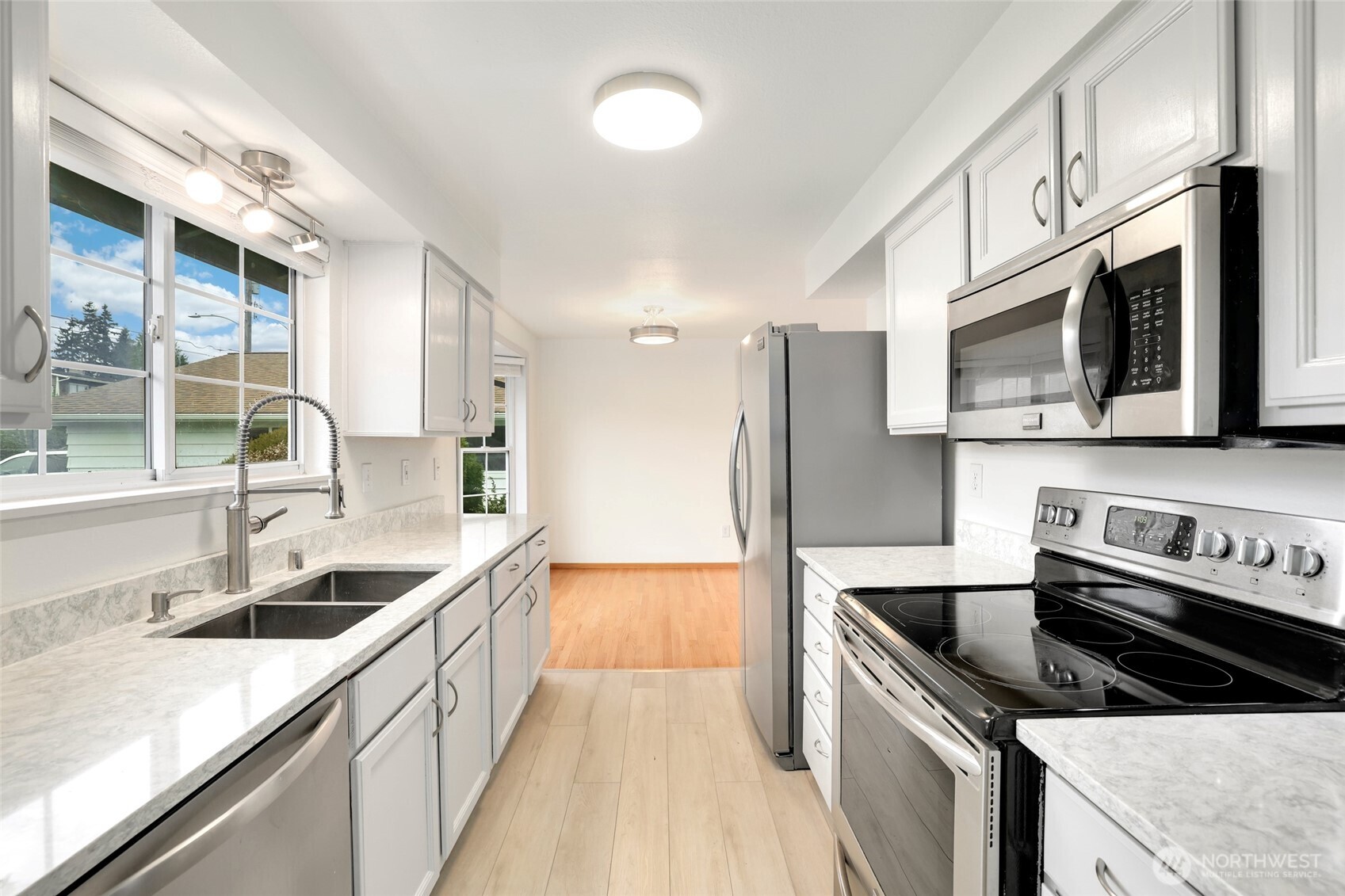 4609 North Vassault Street Tacoma, WA 98407 - Photo 15 of 37 a kitchen with stainless steel appliances granite countertop a sink stove microwave and cabinets