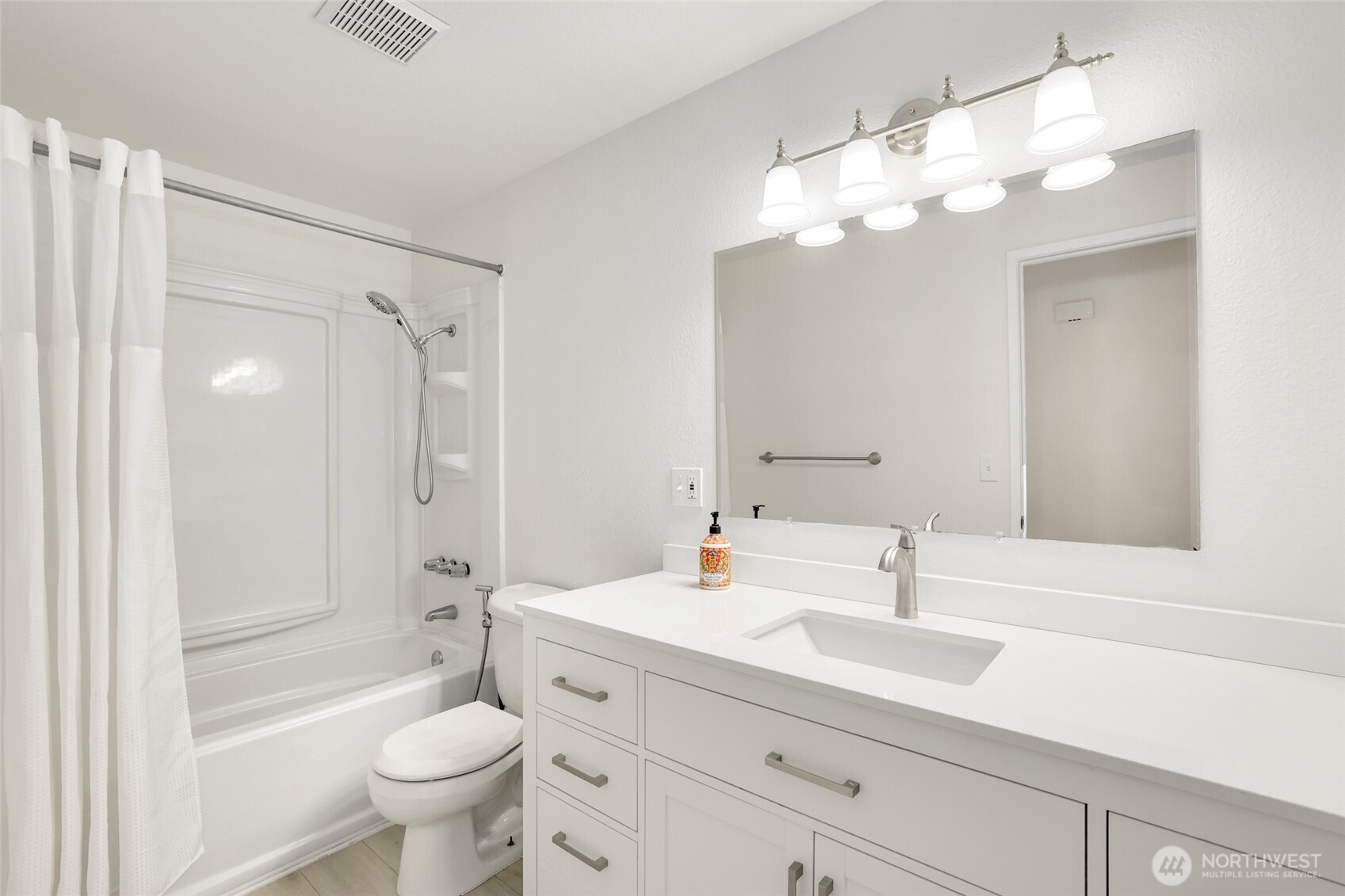 4609 North Vassault Street Tacoma, WA 98407 - Photo 20 of 37 a bathroom with a sink a toilet a mirror and shower
