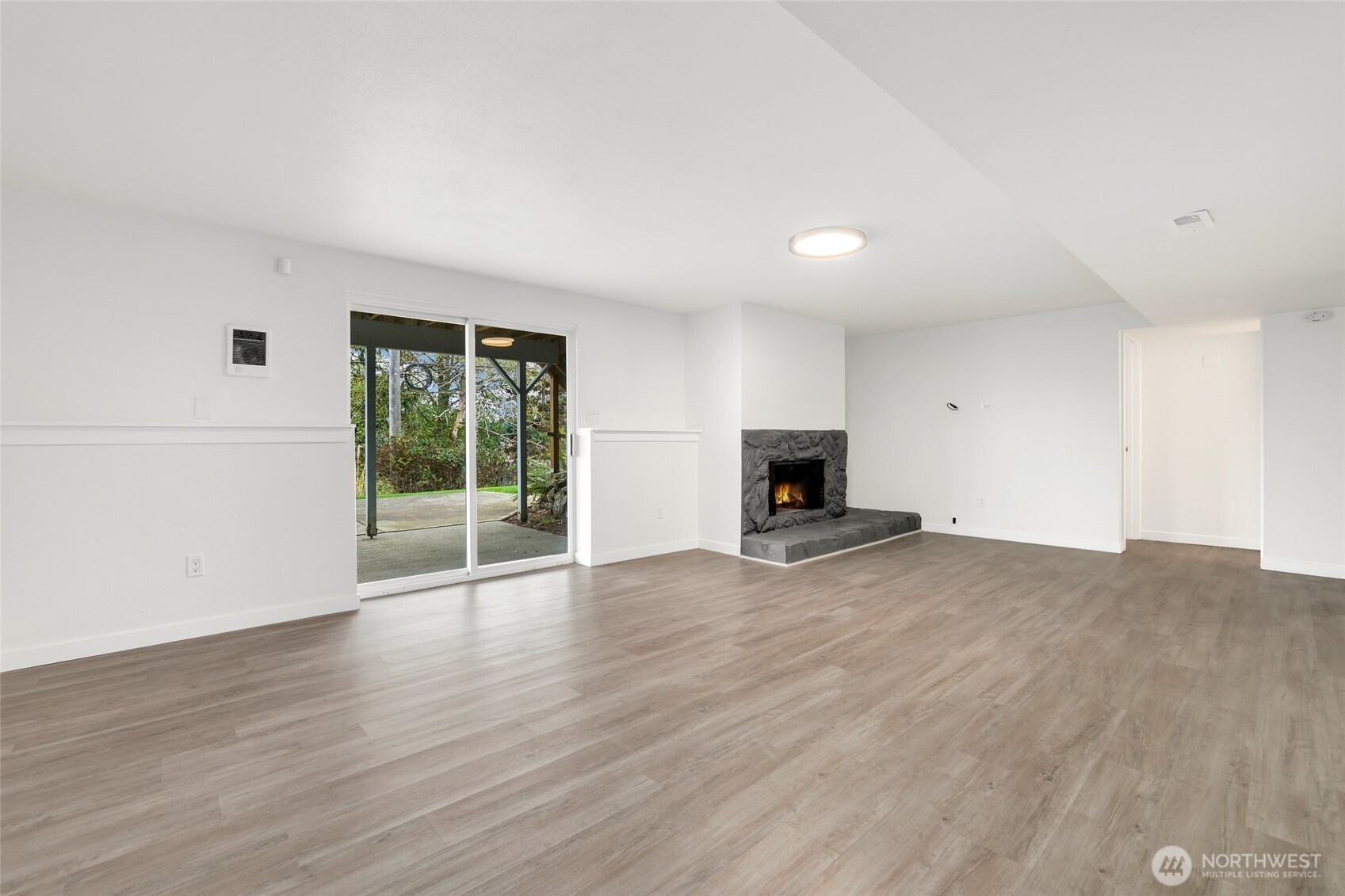 4609 North Vassault Street Tacoma, WA 98407 - Photo 24 of 37 a view of empty room with wooden floor and fireplace