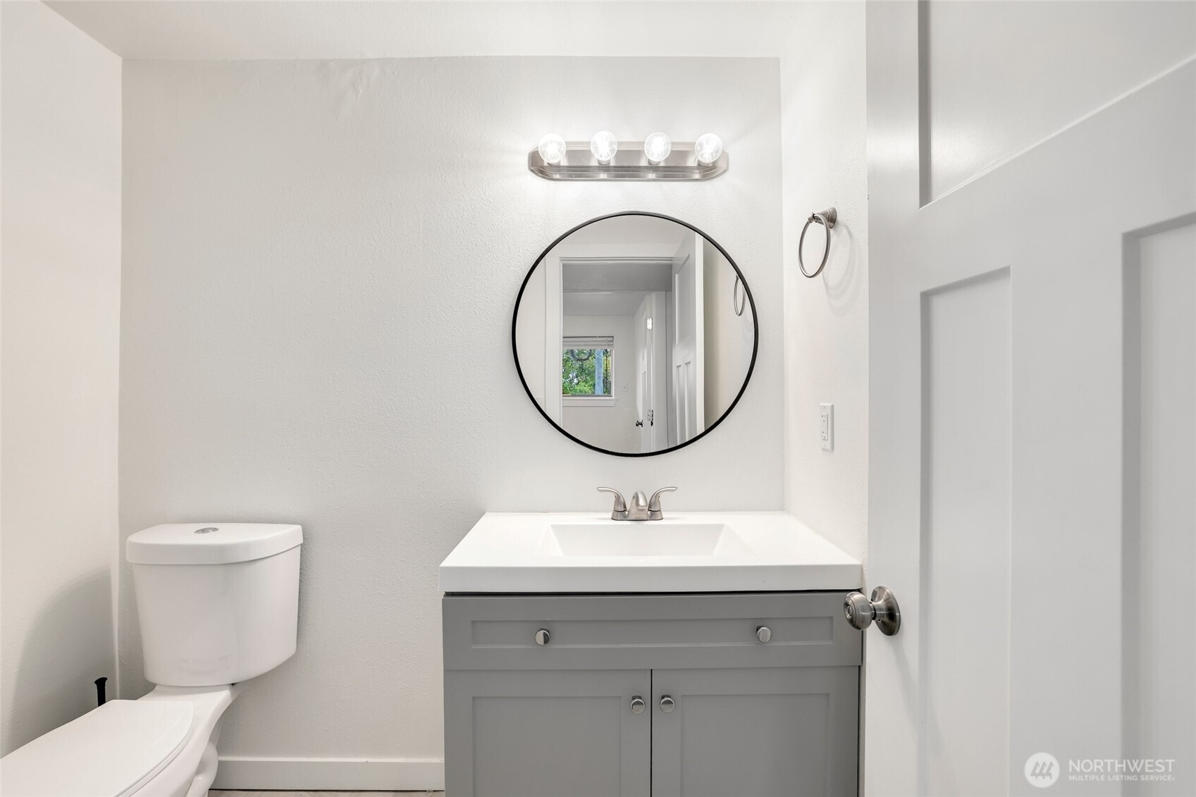 4609 North Vassault Street Tacoma, WA 98407 - Photo 25 of 37 a bathroom with a toilet a sink and a mirror