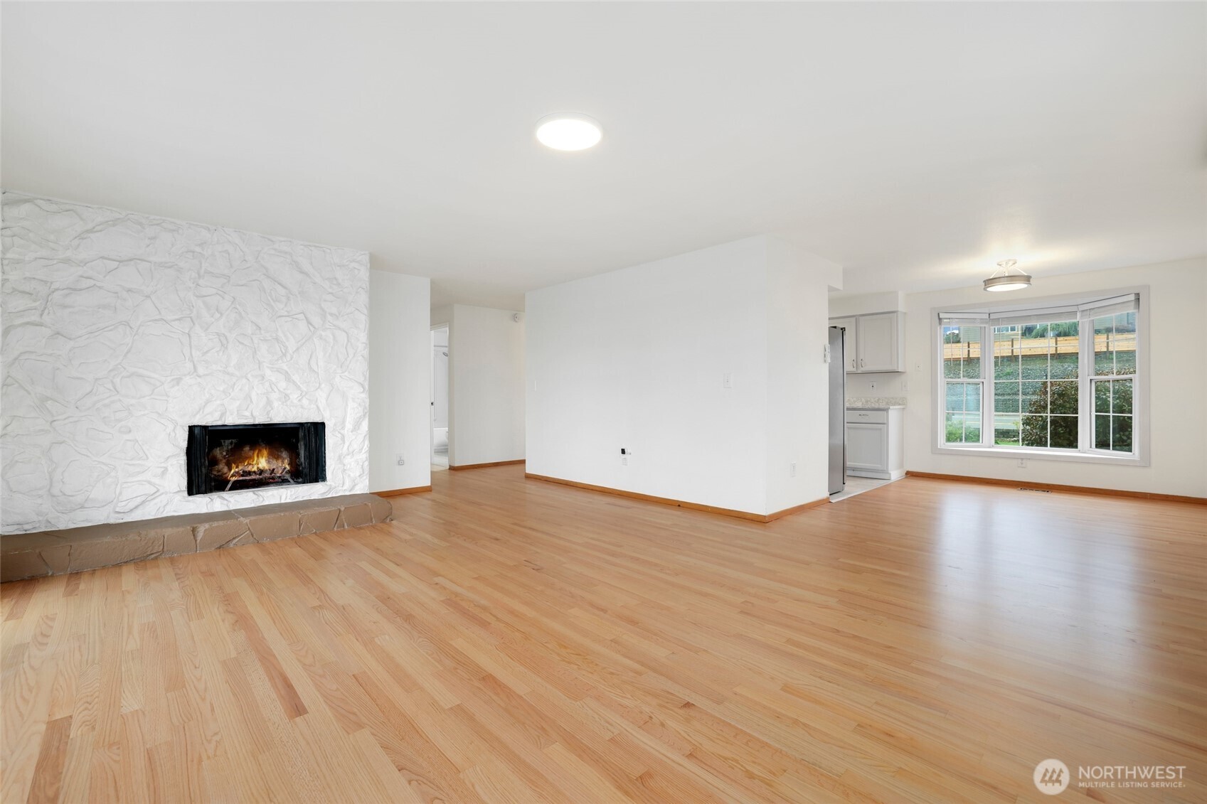 4609 North Vassault Street Tacoma, WA 98407 - Photo 4 of 37 a view of an empty room with wooden floor and a window