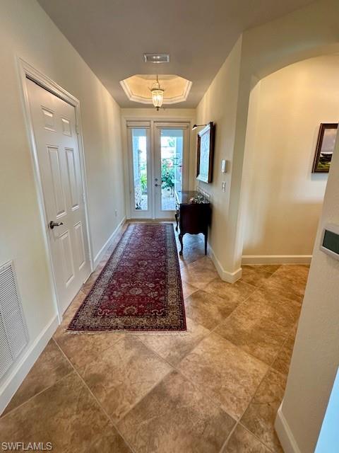 9221 Quartz Lane, Unit 9102 Naples, FL 34120 - Photo 2 of 19 Entrance foyer with baseboards, visible vents, and a raised ceiling