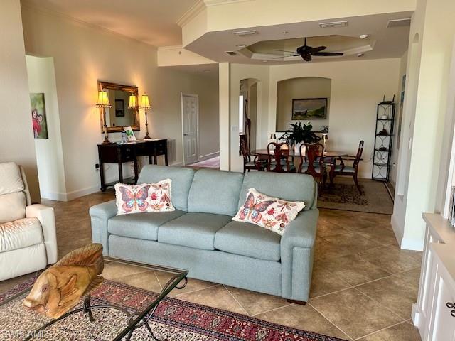 9221 Quartz Lane, Unit 9102 Naples, FL 34120 - Photo 5 of 19 Tiled living area with a tray ceiling, a ceiling fan, visible vents, arched walkways, and ornamental molding