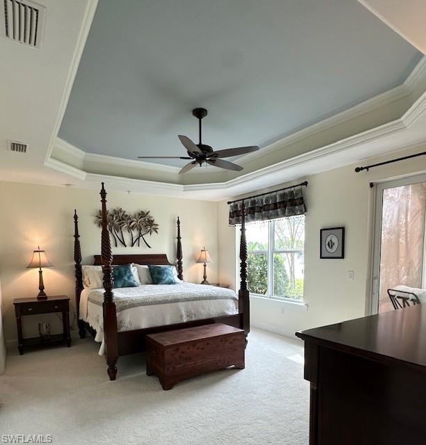 9221 Quartz Lane, Unit 9102 Naples, FL 34120 - Photo 7 of 19 Bedroom featuring a raised ceiling, light carpet, crown molding, and visible vents