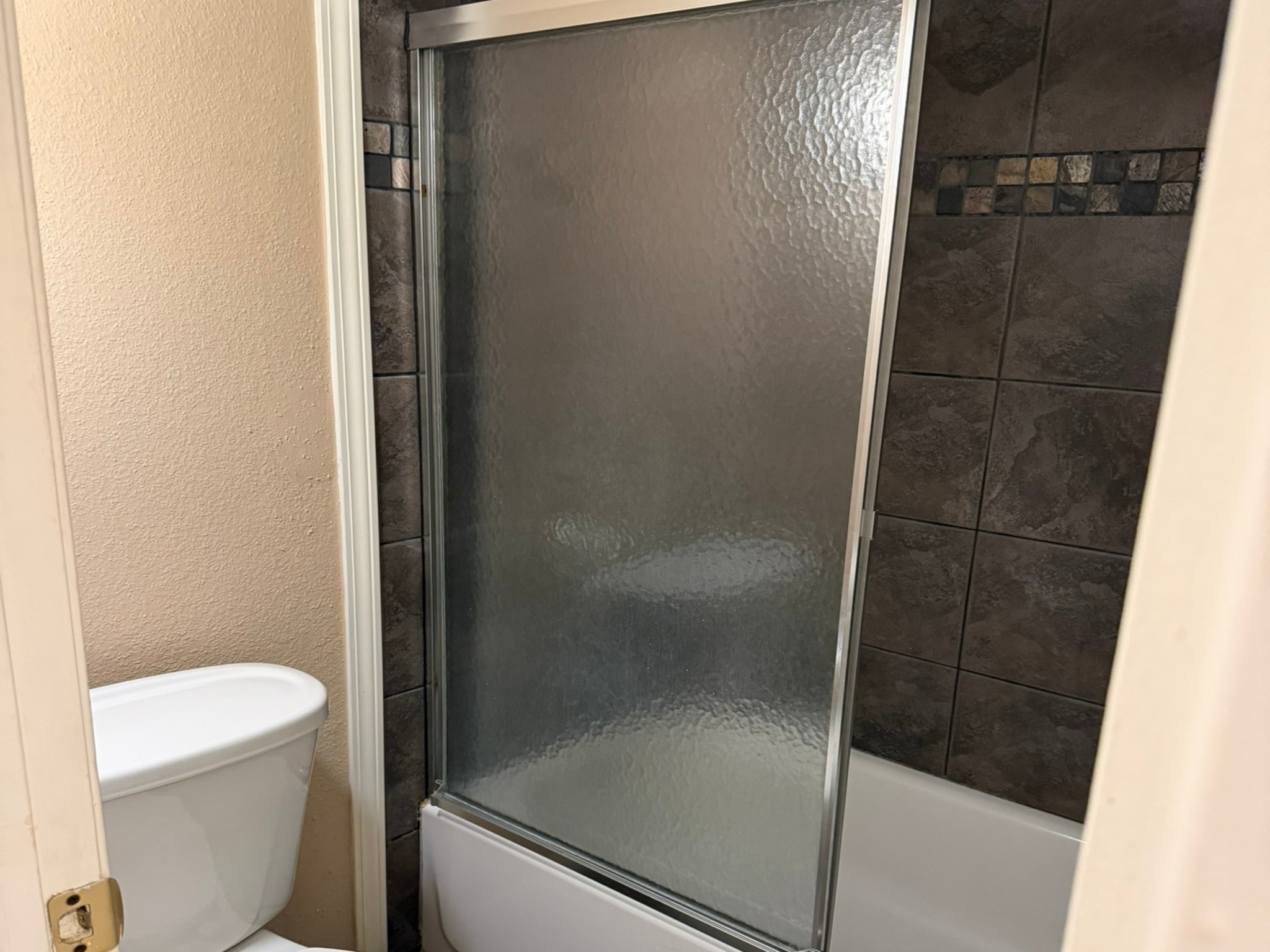 9000 Bissonnet Street, Unit 512 Houston, TX 77074 - Photo 9 of 13 a bathroom with a shower and toilet