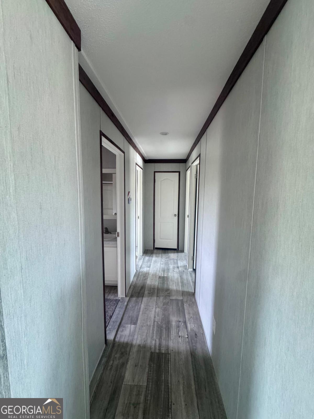 67 Long Leaf Road Hazlehurst, GA 31539 - Photo 11 of 17 a view of a hallway with wooden floor