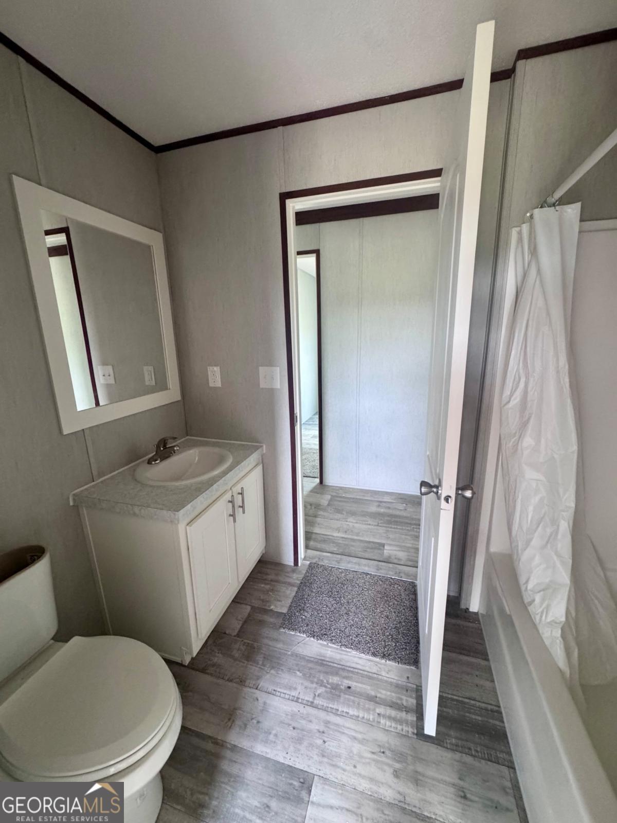 67 Long Leaf Road Hazlehurst, GA 31539 - Photo 15 of 17 a bathroom with a toilet sink and a mirror