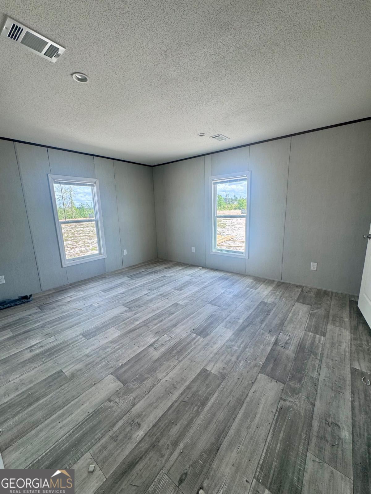 67 Long Leaf Road Hazlehurst, GA 31539 - Photo 8 of 17 a view of empty room with windows