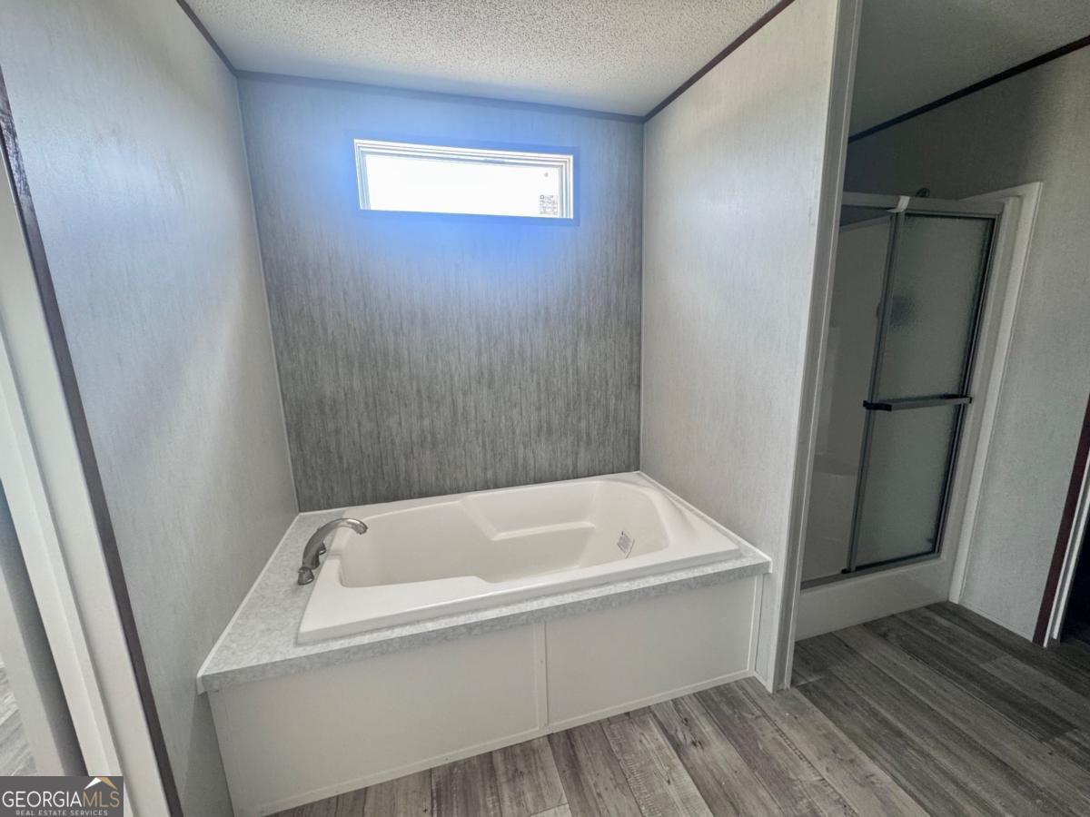 67 Long Leaf Road Hazlehurst, GA 31539 - Photo 10 of 17 a bathroom with a bathtub and a shower