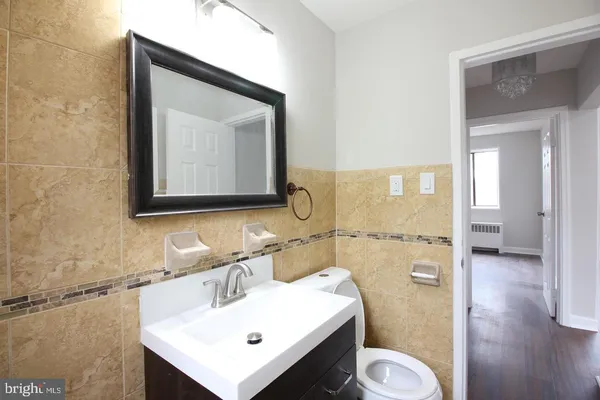 a bathroom with a toilet sink and mirror