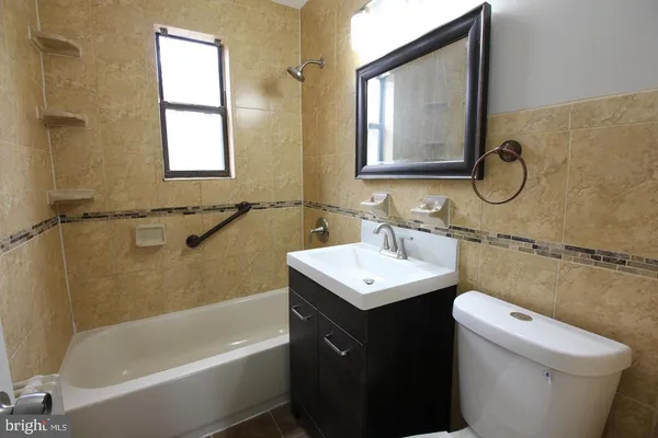 a bathroom with a sink toilet and tub