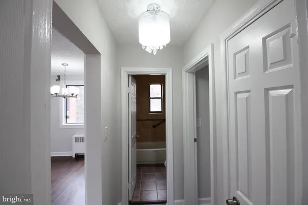 a view of a hallway with wooden shelves
