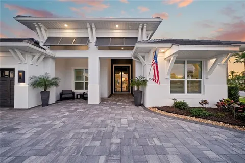a view of a house with potted plants in front of door
