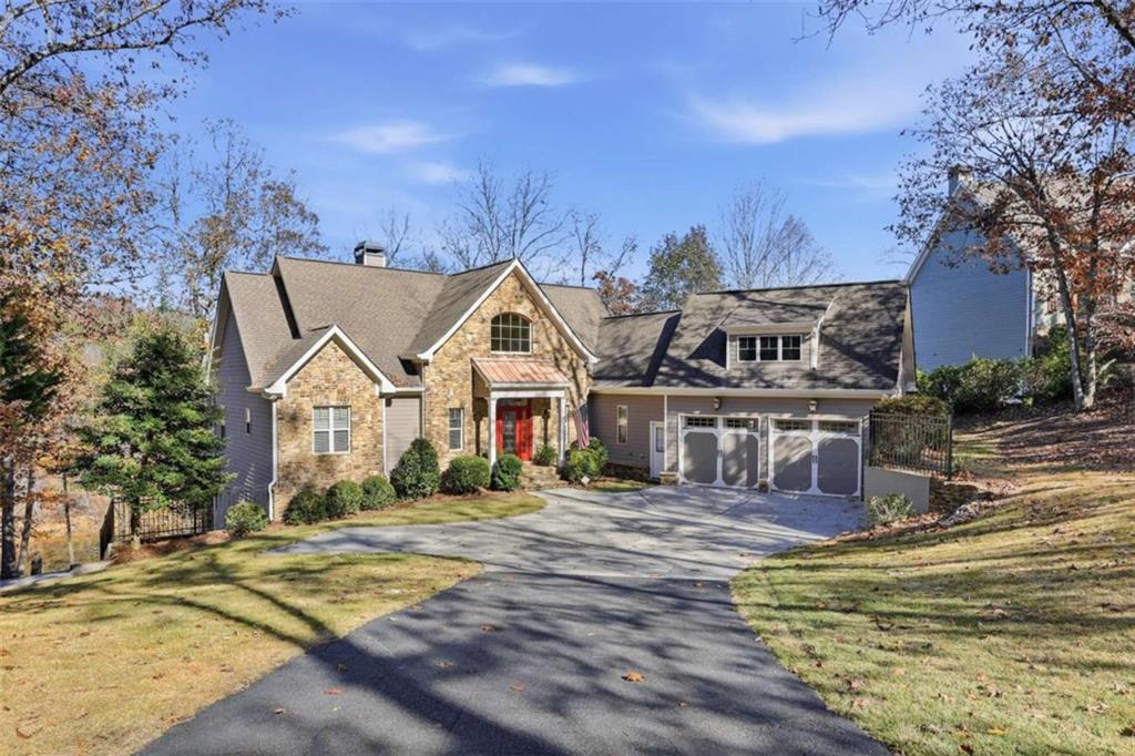 a view of a house with a big yard and large trees