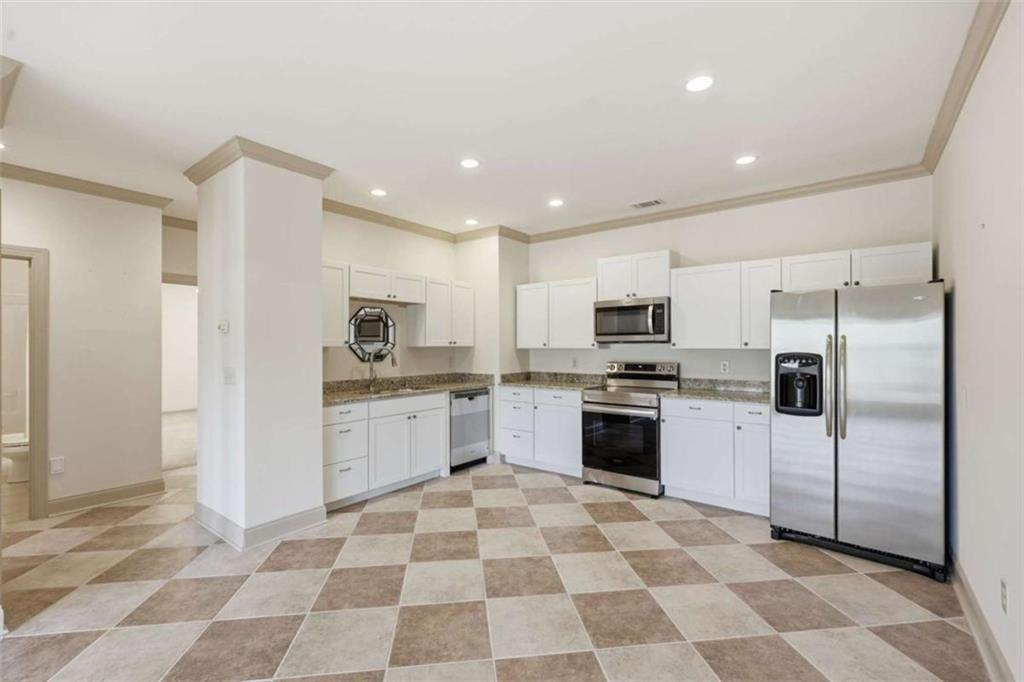 5264 Laurel Circle Gainesville, GA 30506 - Photo 23 of 47 a kitchen with stainless steel appliances granite countertop a refrigerator and a stove top oven