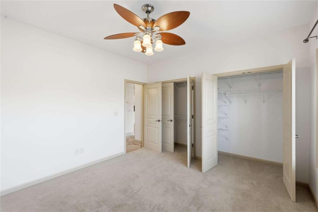 5264 Laurel Circle Gainesville, GA 30506 - Photo 28 of 47 an empty room with closet and a chandelier fan