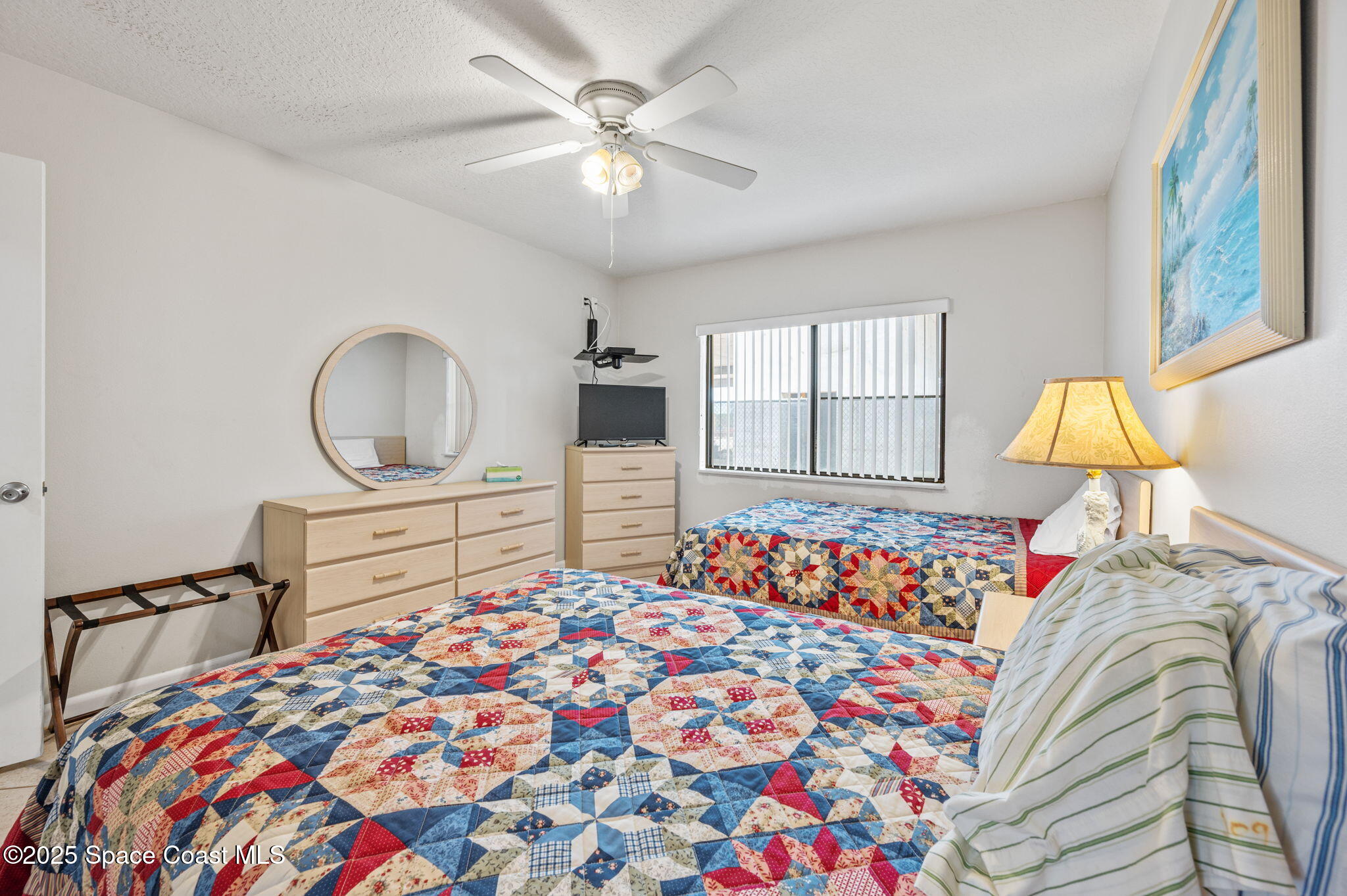 Undisclosed Address Cocoa Beach, FL 32931 - Photo 12 of 23 a bedroom with bed and a chandelier