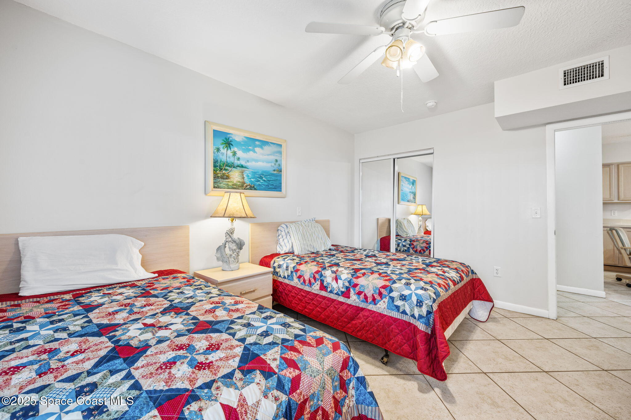 Undisclosed Address Cocoa Beach, FL 32931 - Photo 13 of 23 a bedroom with a bed and a chandelier