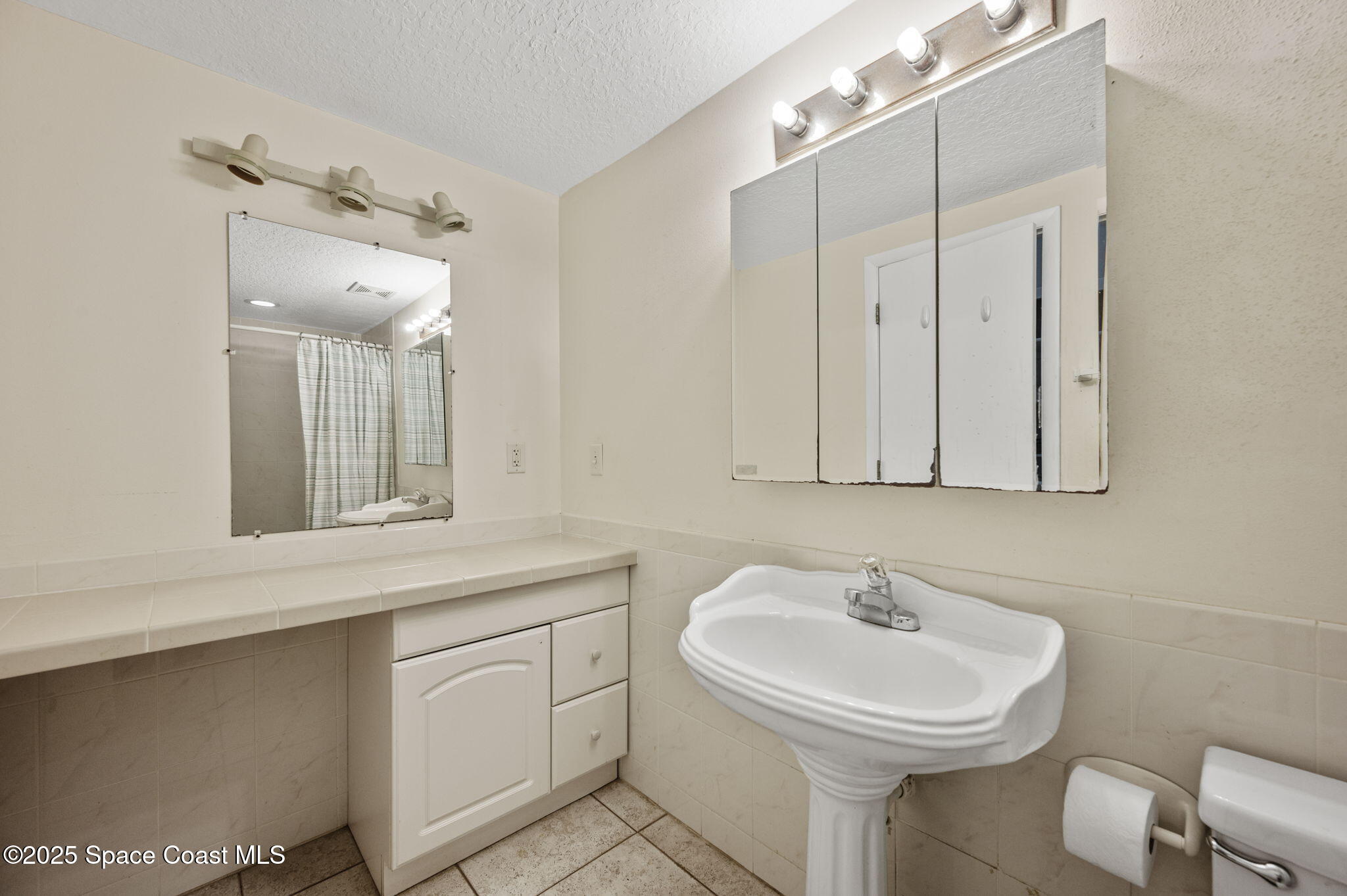 Undisclosed Address Cocoa Beach, FL 32931 - Photo 16 of 23 a bathroom with a sink and a mirror