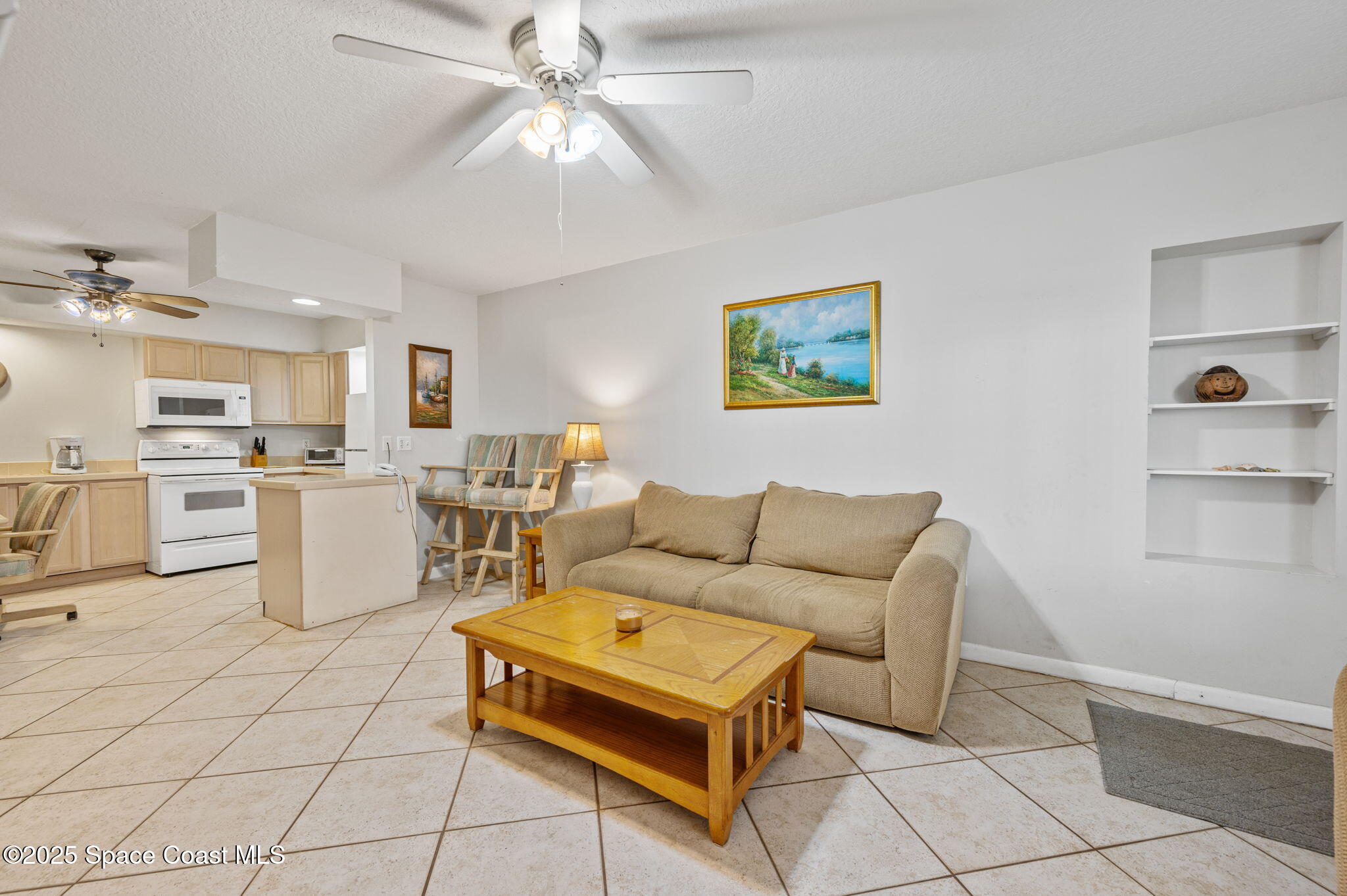 Undisclosed Address Cocoa Beach, FL 32931 - Photo 6 of 23 a living room with a couch and a dining table