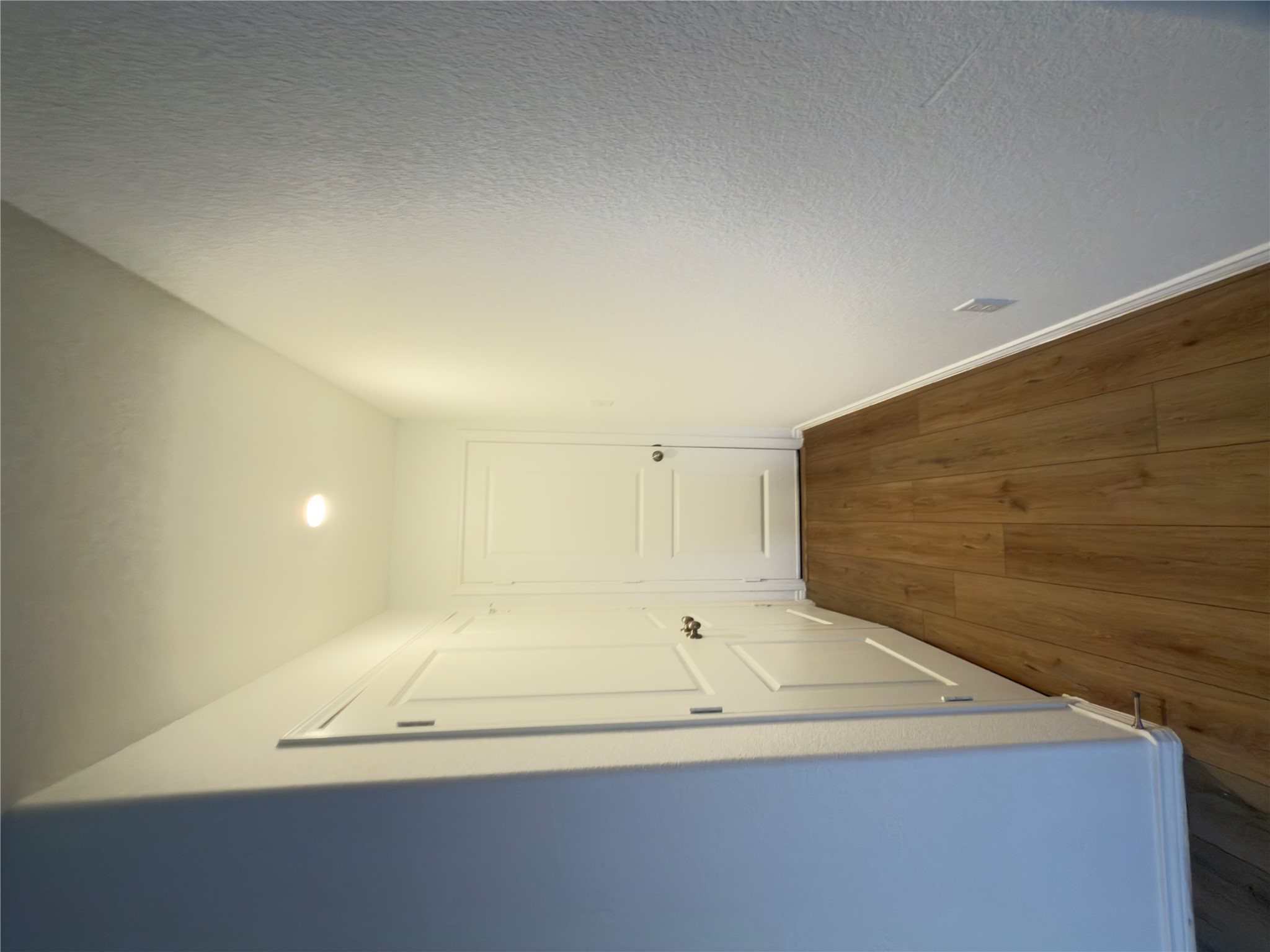 13336 Illumination Road Elgin, TX 78621 - Photo 13 of 15 a view of a hallway with wooden floor
