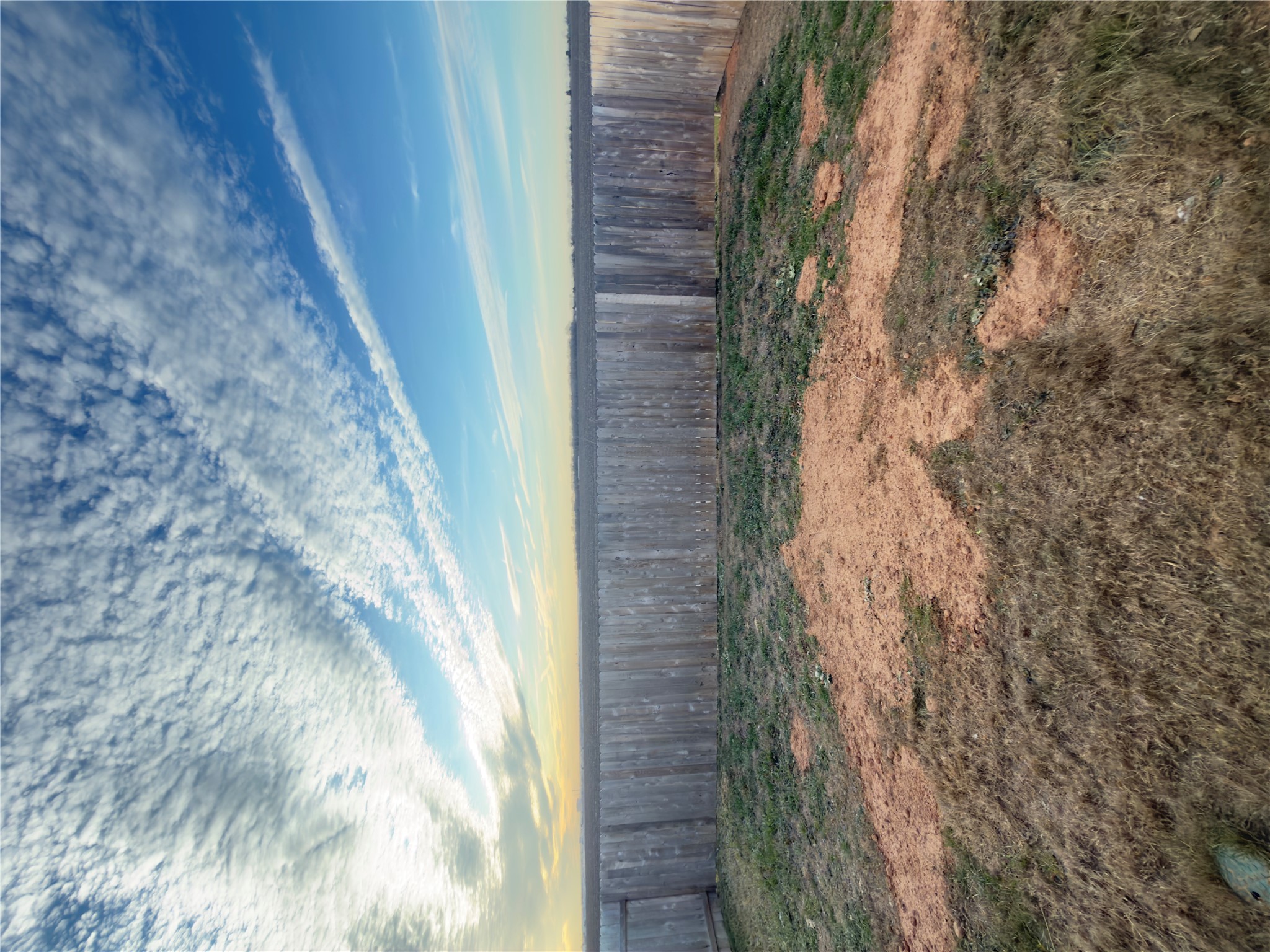13336 Illumination Road Elgin, TX 78621 - Photo 14 of 15 a view of a backyard with wooden fence